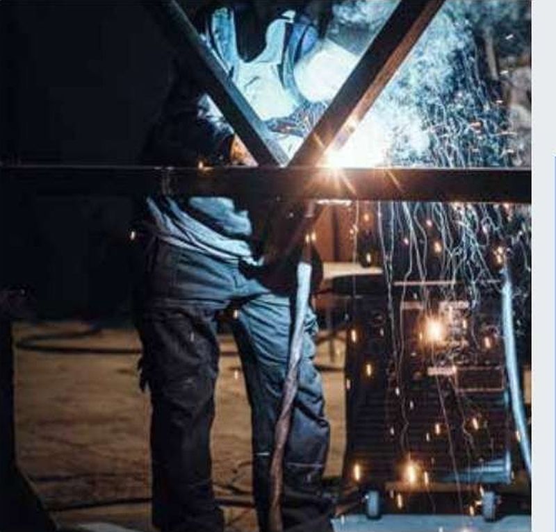 Welder joining structural steel members in the ADSD workshop
