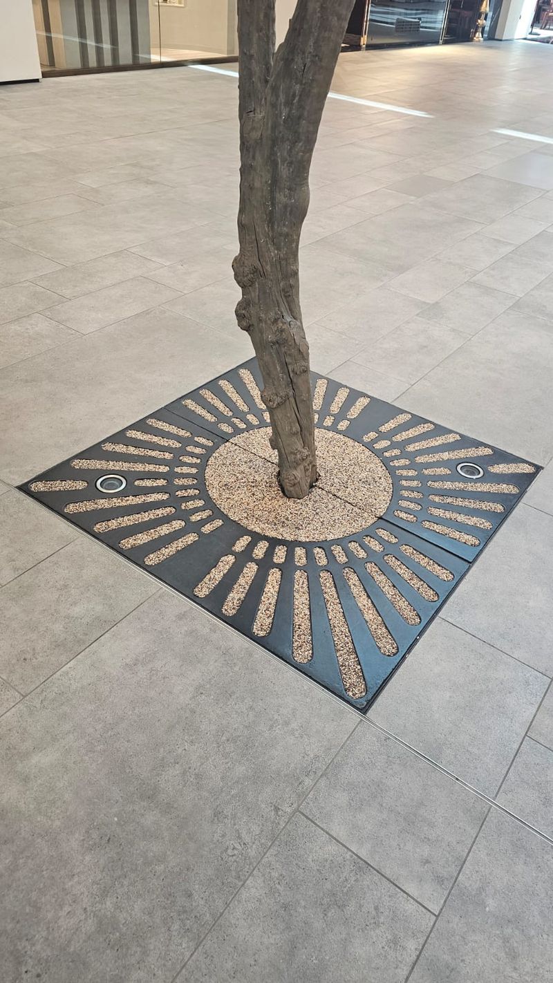 Decorative sunburst tree grate, mall floor